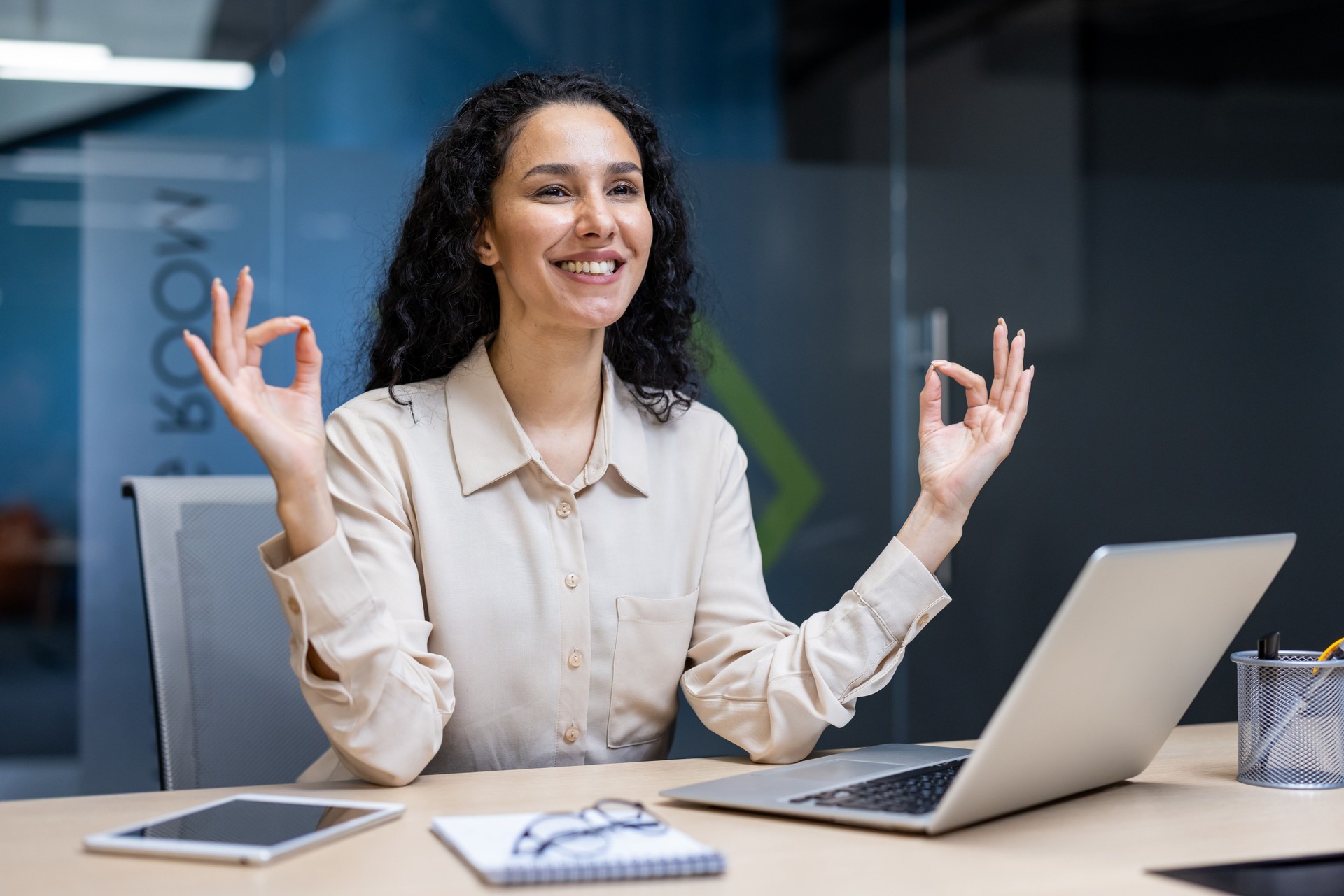Businesswoman practicing mindfulness meditation at her desk in the office